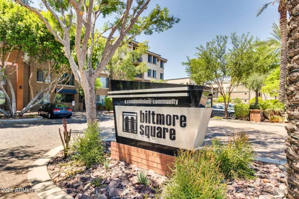 a view of street with sign board and yard