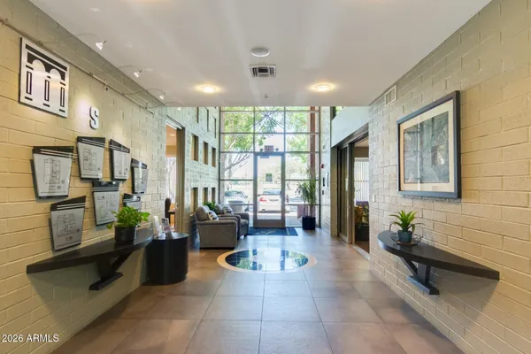 a lobby with furniture and large windows