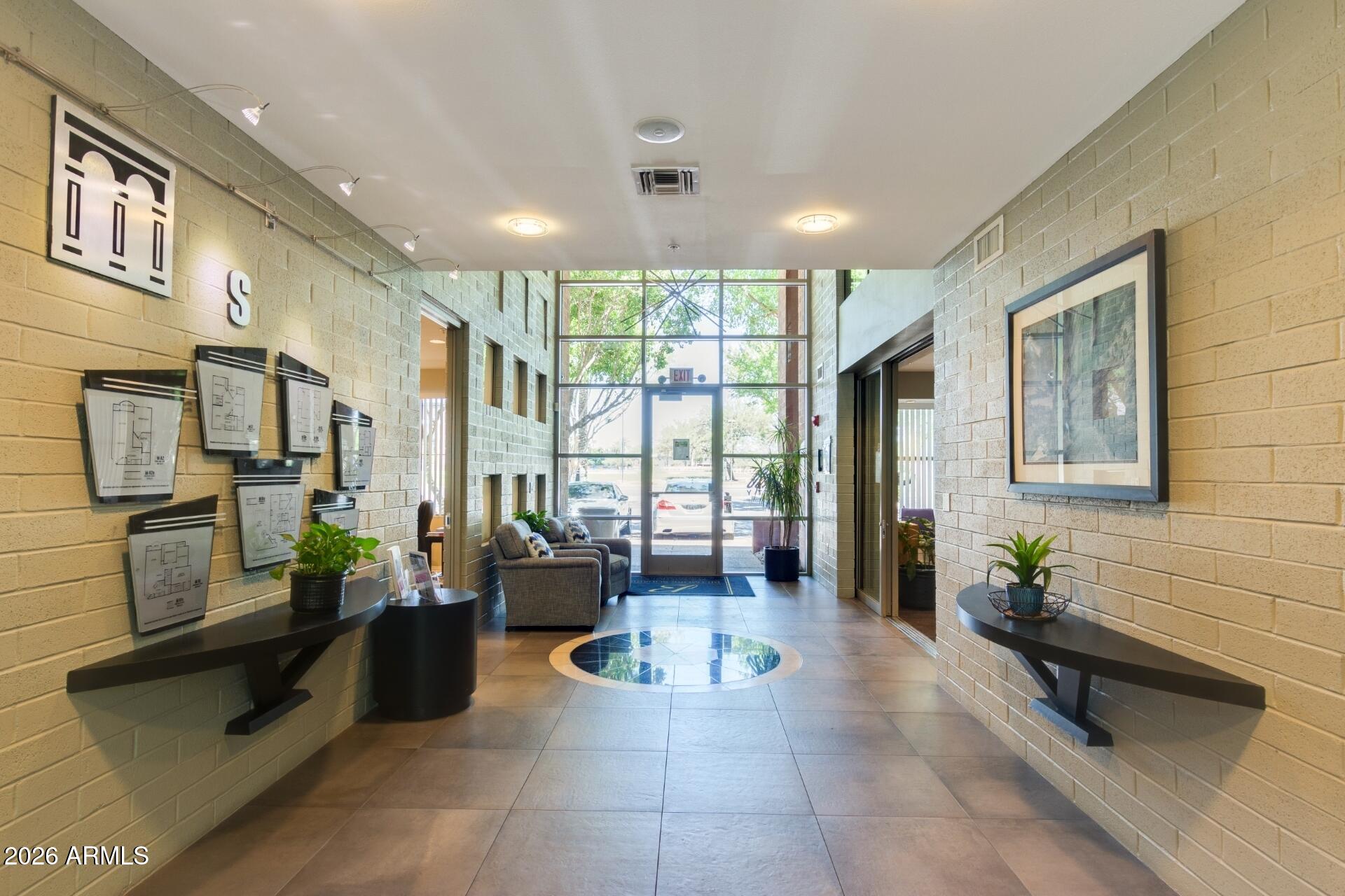 1701 East Colter Street, Unit 477 Phoenix, AZ 85016 - Photo 25 of 39 a lobby with furniture and large windows