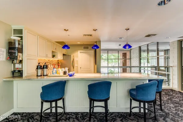a kitchen with stainless steel appliances kitchen island granite countertop a dining table and chairs