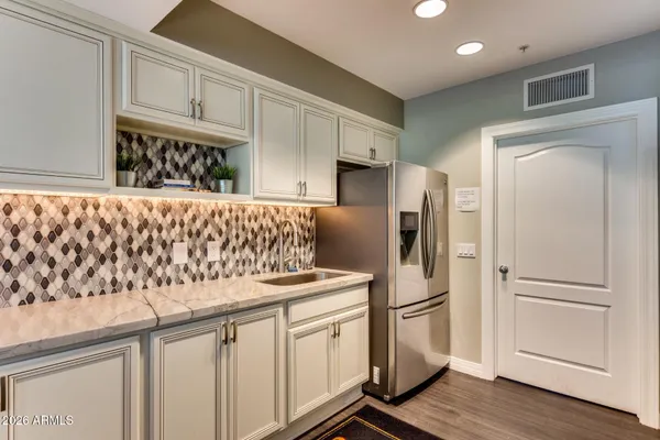 a kitchen with stainless steel appliances granite countertop a refrigerator sink and cabinets