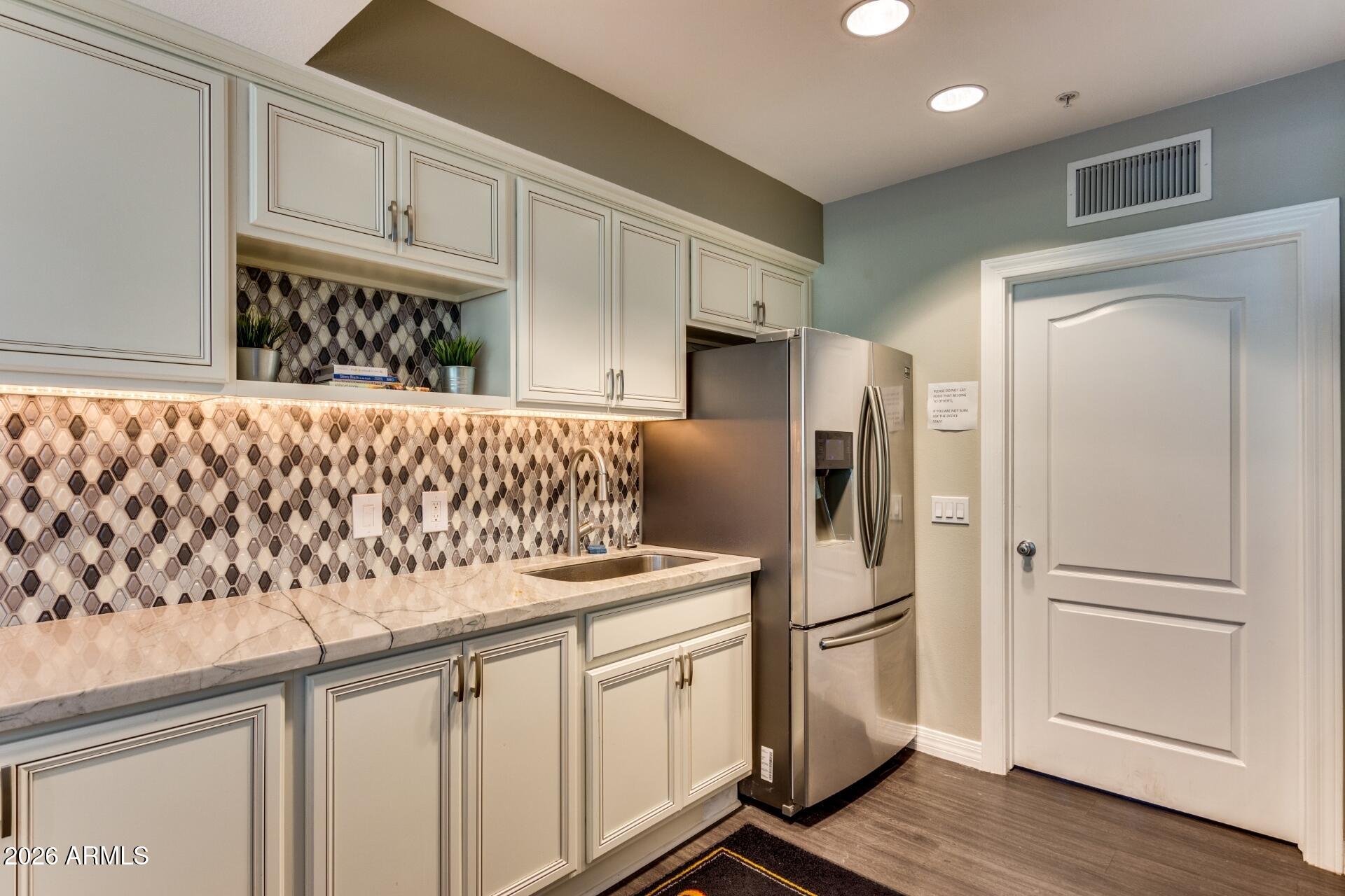 1701 East Colter Street, Unit 477 Phoenix, AZ 85016 - Photo 27 of 39 a kitchen with stainless steel appliances granite countertop a refrigerator sink and cabinets
