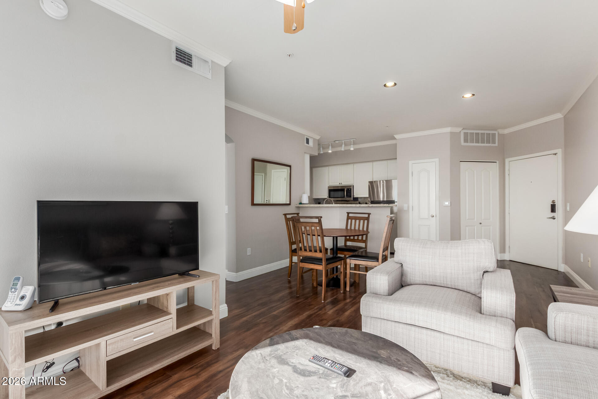 1701 East Colter Street, Unit 477 Phoenix, AZ 85016 - Photo 3 of 39 a living room with furniture and a flat screen tv