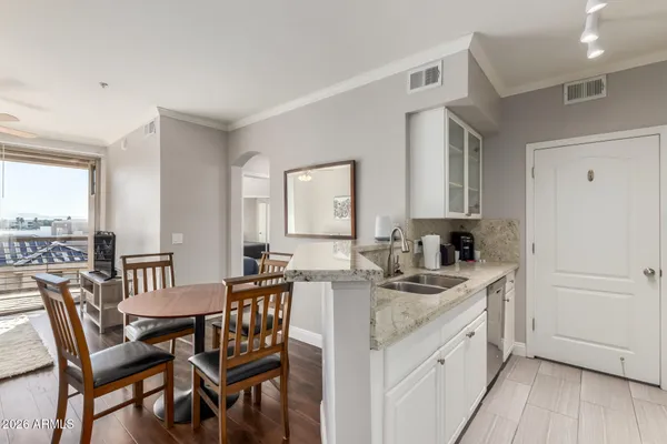 a kitchen that has a table and chairs in it