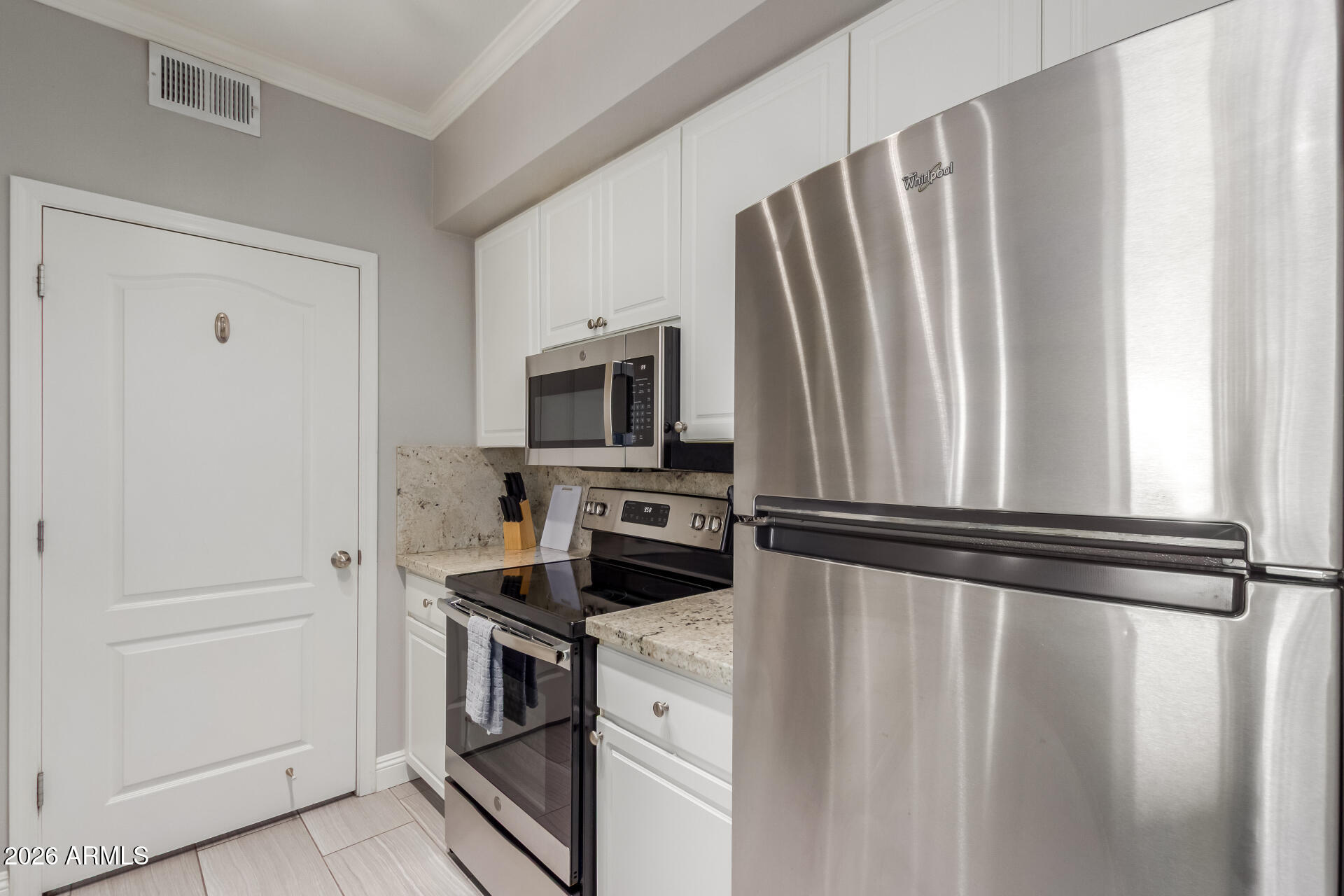 1701 East Colter Street, Unit 477 Phoenix, AZ 85016 - Photo 7 of 39 a kitchen with stainless steel appliances a refrigerator stove and microwave