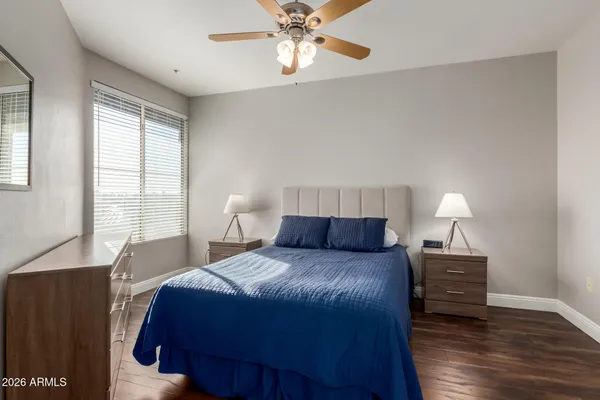 a bedroom with a bed and a night stand