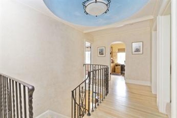 101 Stuart Road Newton, MA 02459 - Photo 15 of 26 a view of a hallway with wooden floor and windows