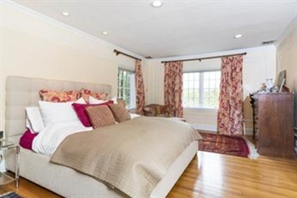 101 Stuart Road Newton, MA 02459 - Photo 16 of 26 a bedroom with a large bed and a chandelier