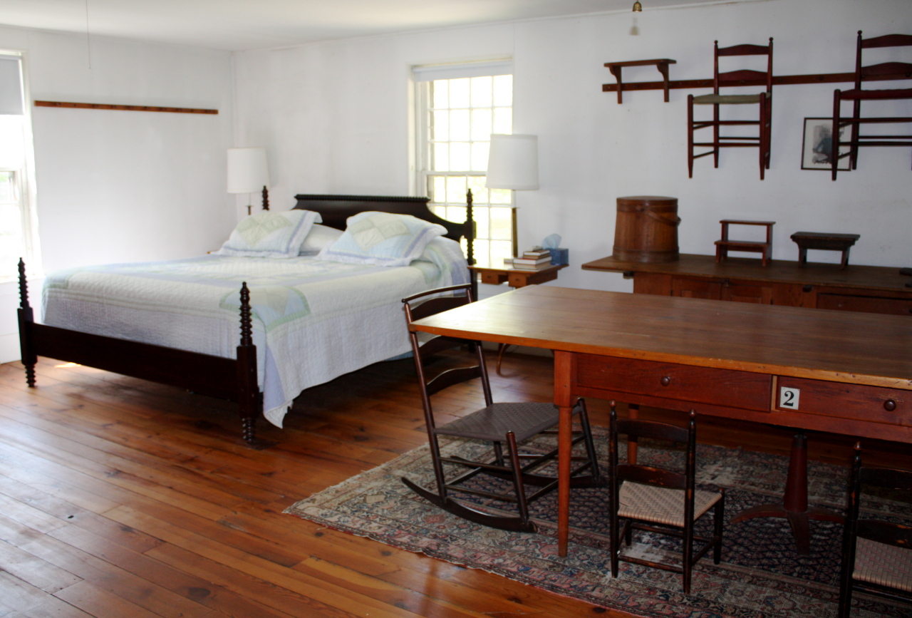 13 Main Road Tyringham, MA 01238 - Photo 14 of 31 a bedroom with a bed and a table