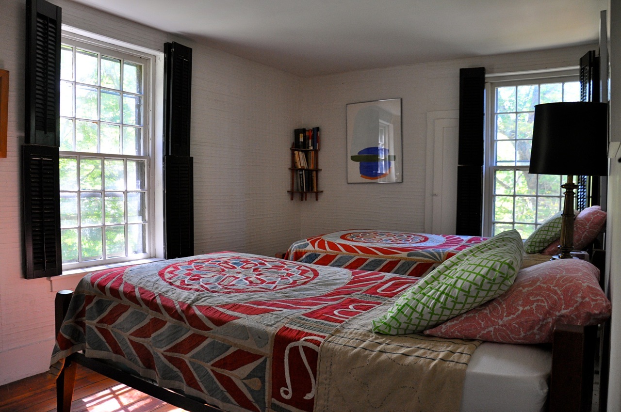 13 Main Road Tyringham, MA 01238 - Photo 23 of 31 a bedroom with a bed and glass windows
