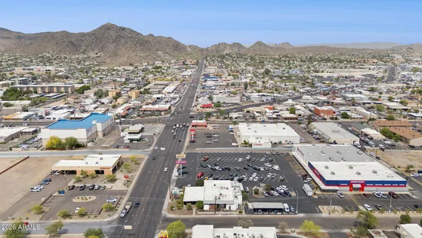an aerial view of residential houses with city view