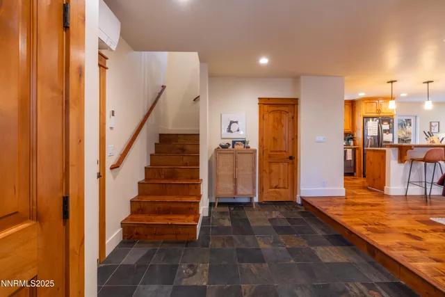 a view of a hallway with wooden floor and staircase
