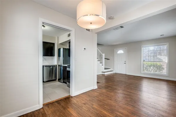 an empty room with wooden floor and a window