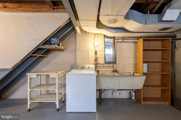 a kitchen with white cabinets and appliances