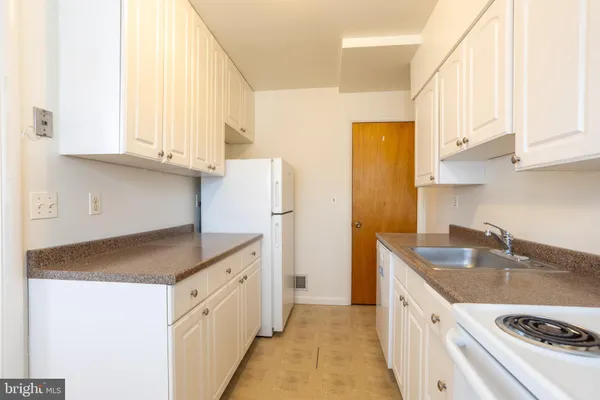 a kitchen with a sink a stove and a cabinets
