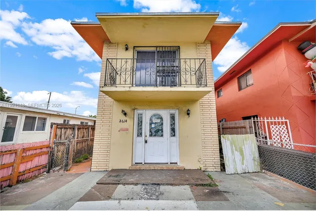 a front view of a house with glass windows and door