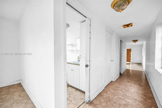 a bathroom with a tub a sink and a window