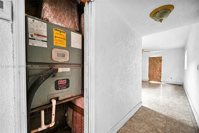 a view of a kitchen with a refrigerator and a sink