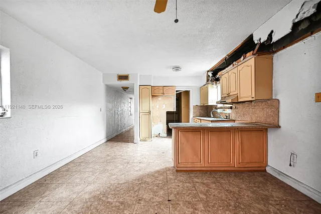 a kitchen that has a cabinets a sink a window and stainless steel appliances