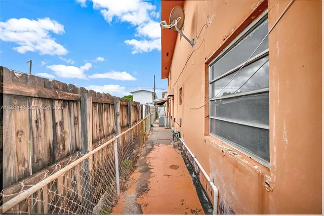 a view of balcony with wooden floor and fence and a ceiling fan