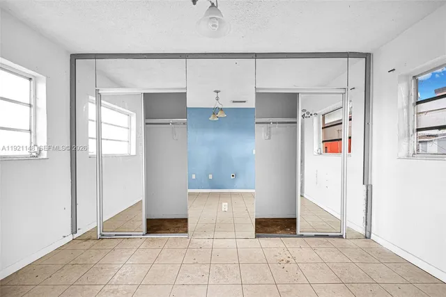 a view of a house with wooden fence