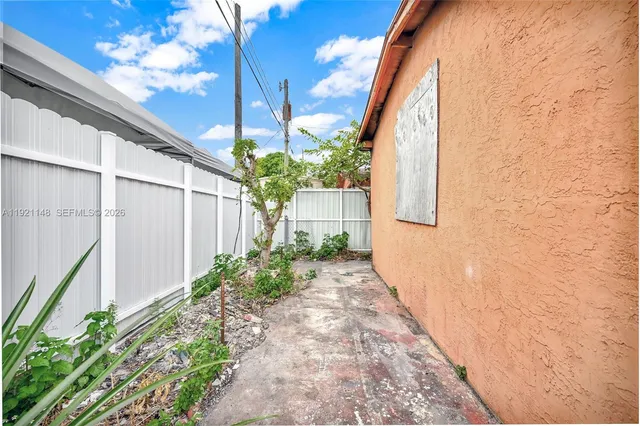 a view of a pathway with a flower plants
