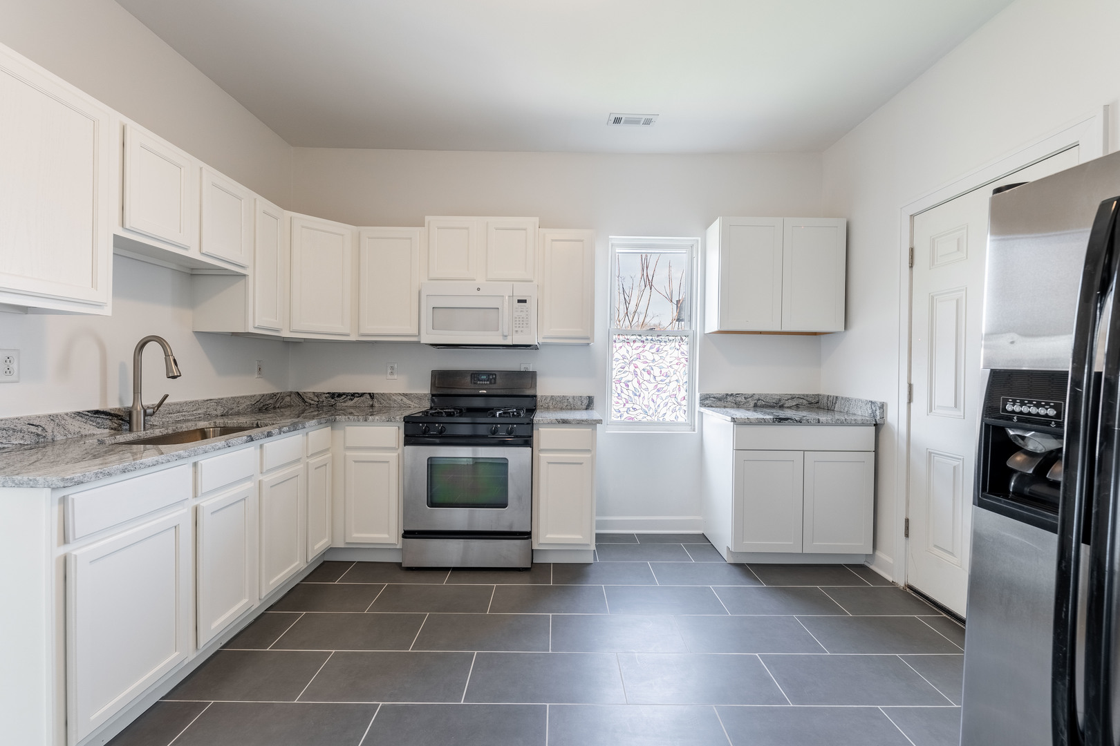 4140 West Maypole Avenue, Unit 2 Chicago, IL 60624 - Photo 11 of 24 a kitchen with a sink stove and refrigerator