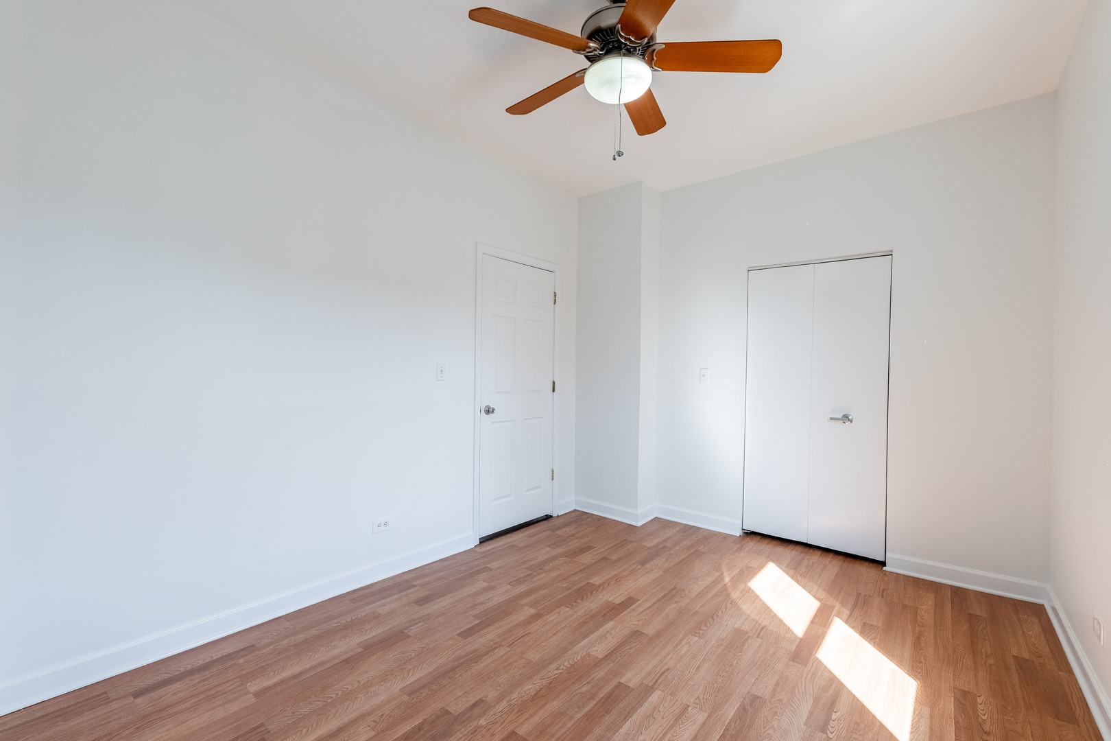 4140 West Maypole Avenue, Unit 2 Chicago, IL 60624 - Photo 15 of 24 a view of a room with wooden floor and a ceiling fan