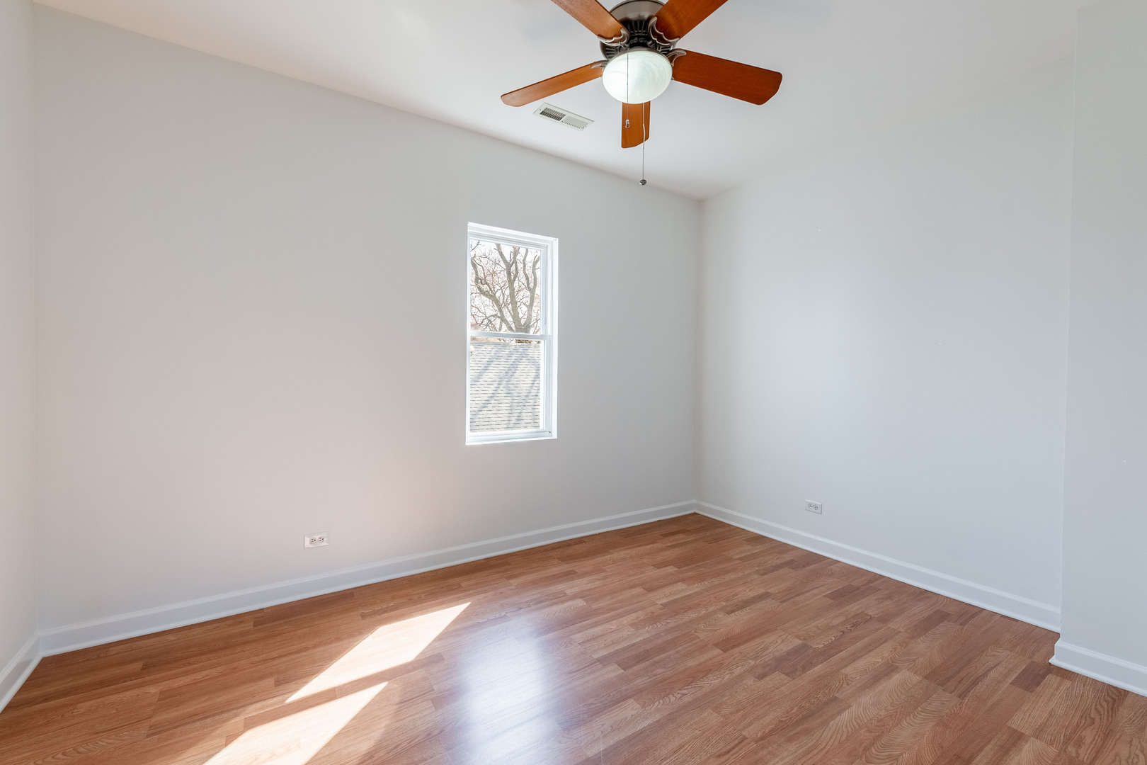 4140 West Maypole Avenue, Unit 2 Chicago, IL 60624 - Photo 16 of 24 an empty room with a window and a fan