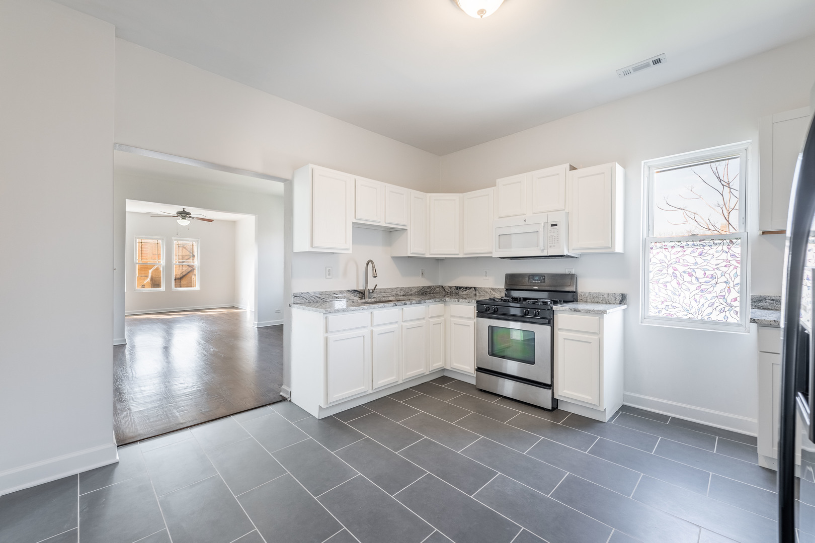 4140 West Maypole Avenue, Unit 2 Chicago, IL 60624 - Photo 9 of 24 a kitchen with a white cabinets and white appliances