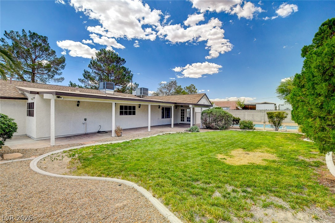 1810 Pinto Road Henderson, NV 89002 - Photo 45 of 53 Relax in the expansive backyard with a refreshing pool, ample patio space, and well-maintained green areas.