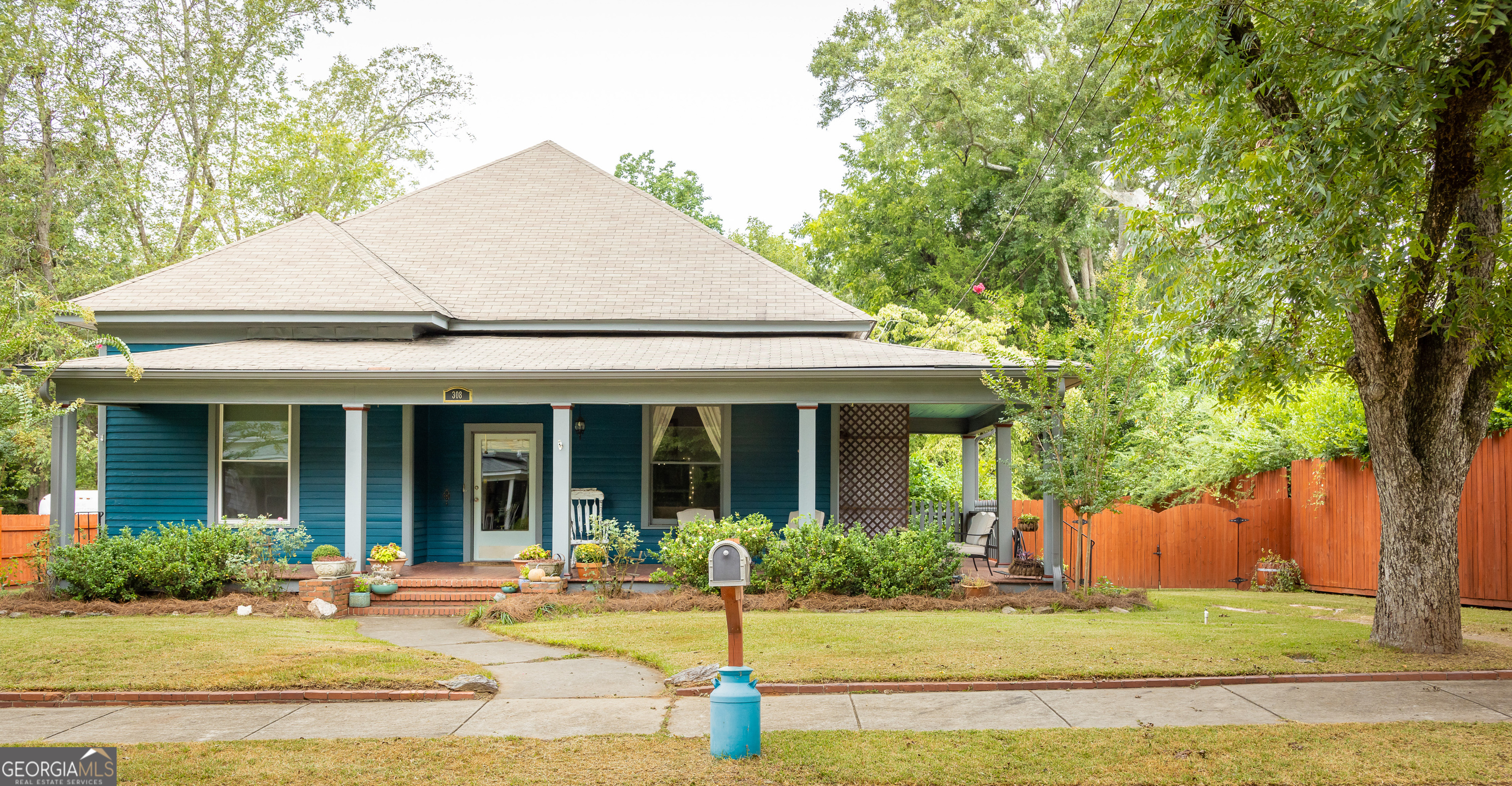 308 Howell Street Thomaston, GA 30286 - Photo 1 of 46 a view of a white house with plants and large tree