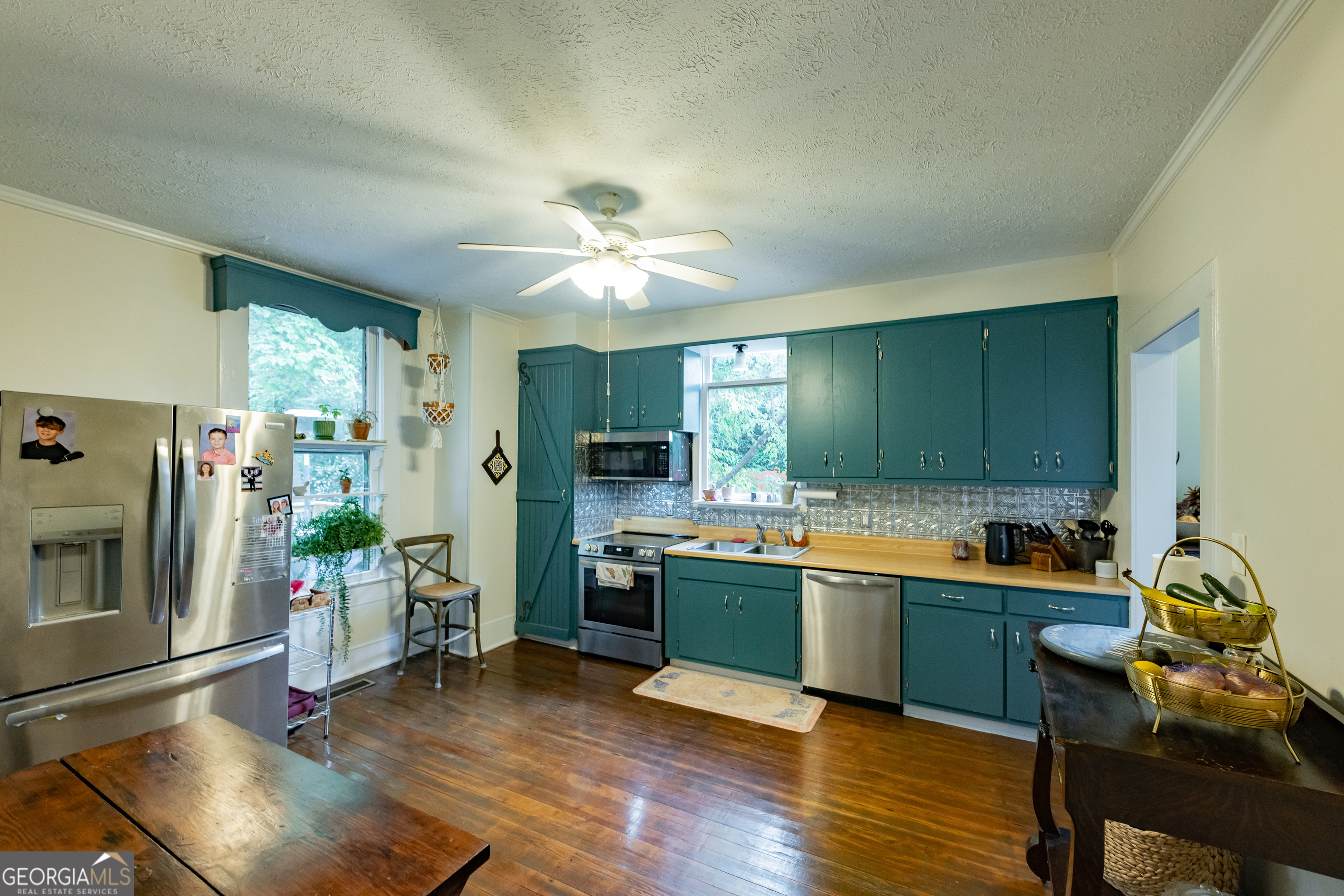 308 Howell Street Thomaston, GA 30286 - Photo 12 of 46 a view of a kitchen with kitchen island a sink and a refrigerator