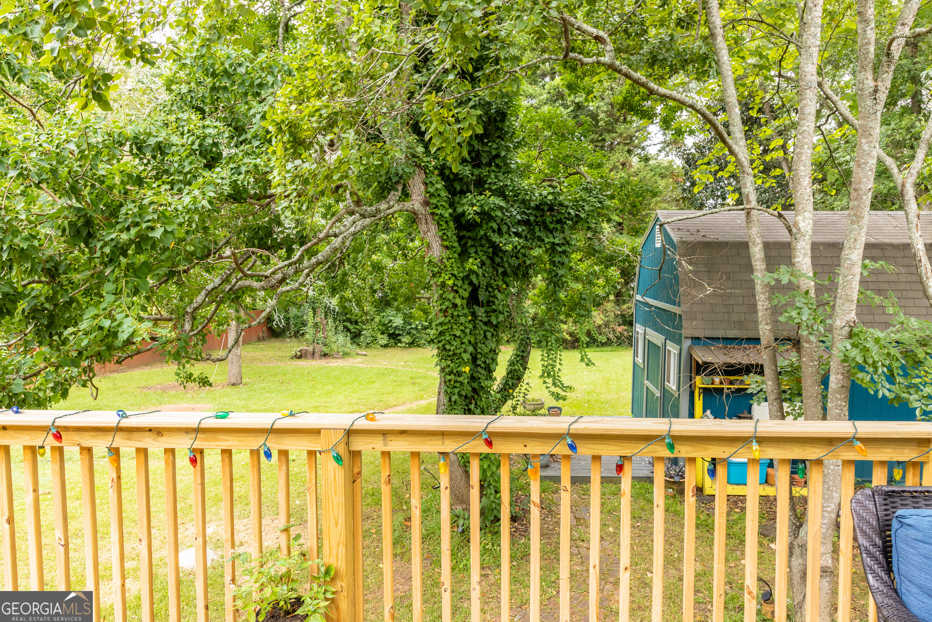 308 Howell Street Thomaston, GA 30286 - Photo 32 of 46 a view of small yard with wooden fence and trees
