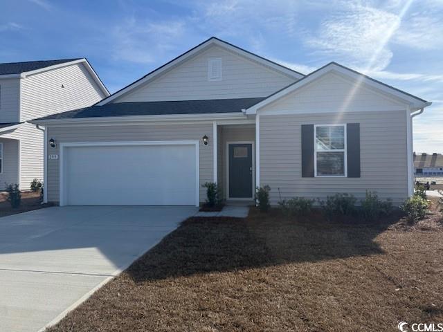 Ranch-style house with an attached garage and concrete driveway