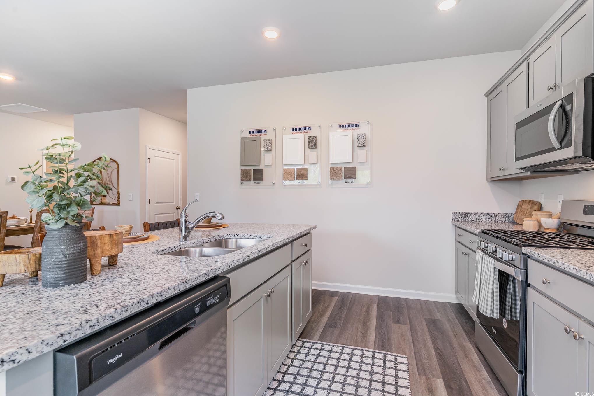 299 Long Beard Way Loris, SC 29569 - Photo 9 of 37 Kitchen featuring stainless steel appliances, gray cabinetry, light stone counters, dark wood finished floors, and recessed lighting