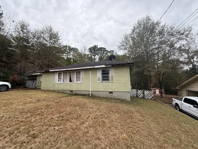 a backyard of a house with table and chairs