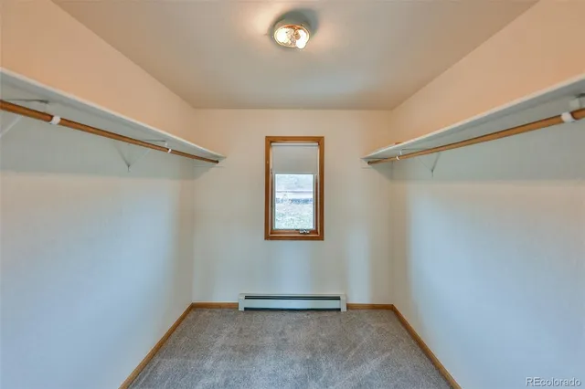 an empty room with windows and ceiling fan