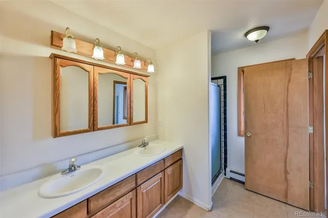 a bathroom with 2 sink and a mirror
