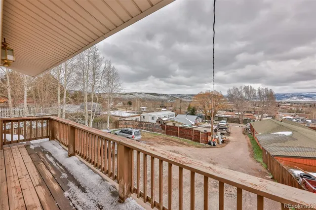 a picture of a wall with a white building and a sign