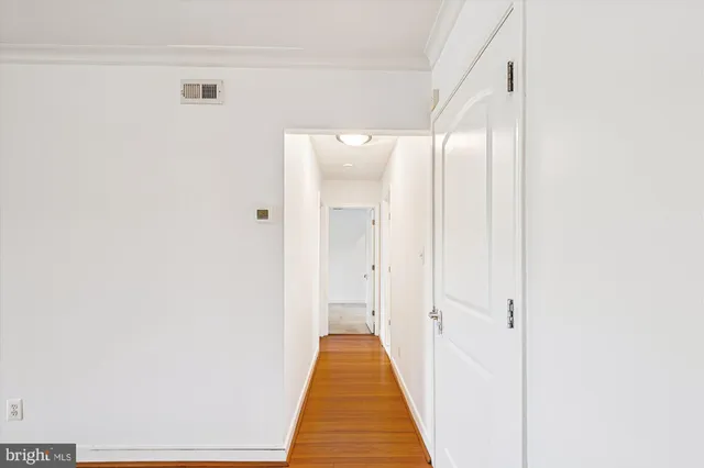 a bathroom with a toilet sink vanity and shower