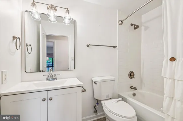 a view of a patio with couches table and chairs and potted plants and large trees
