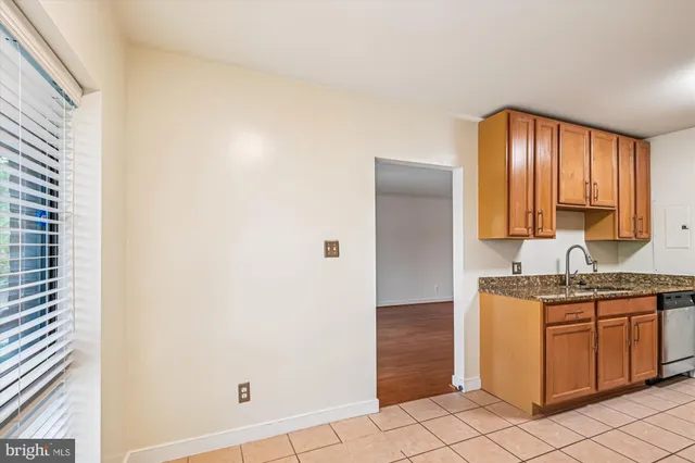 a kitchen with a sink cabinets and utility room