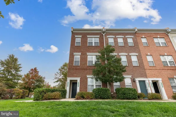 a front view of a residential apartment building with a yard