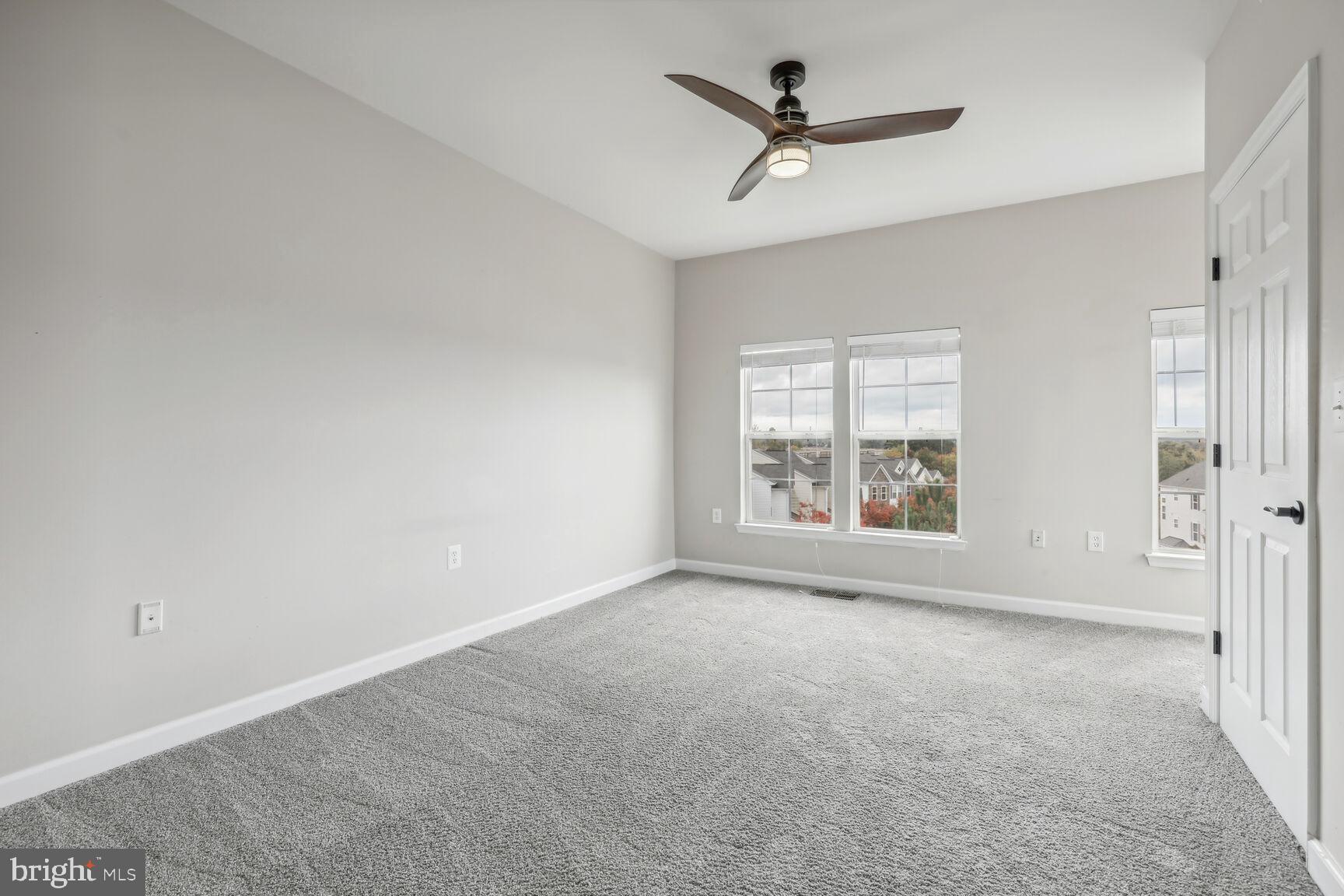 42379 Goldenseal Square Brambleton, VA 20148 - Photo 12 of 20 a view of a livingroom with a ceiling fan and window