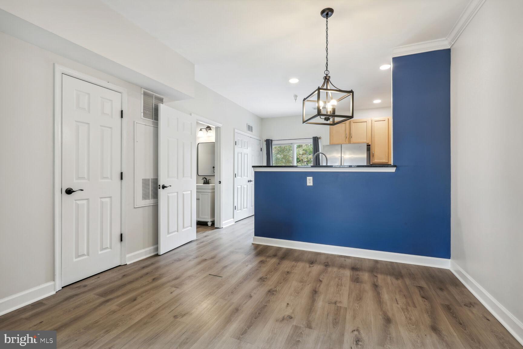 42379 Goldenseal Square Brambleton, VA 20148 - Photo 7 of 20 a view of an empty room with wooden floor and windows