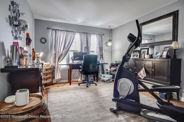 a living room with furniture a piano and a flat screen tv