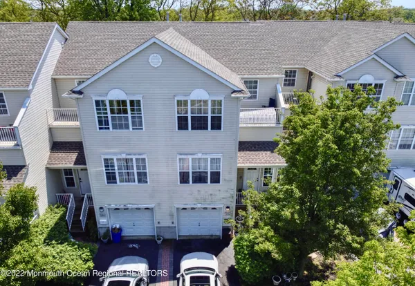 a aerial view of a house with a yard and large trees