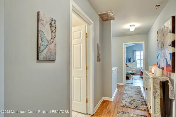 a view of a hallway to rooms