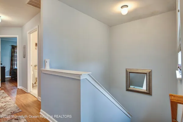 a view of hallway with wooden floor